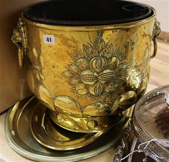 An embossed brass log bin and two brass dishes